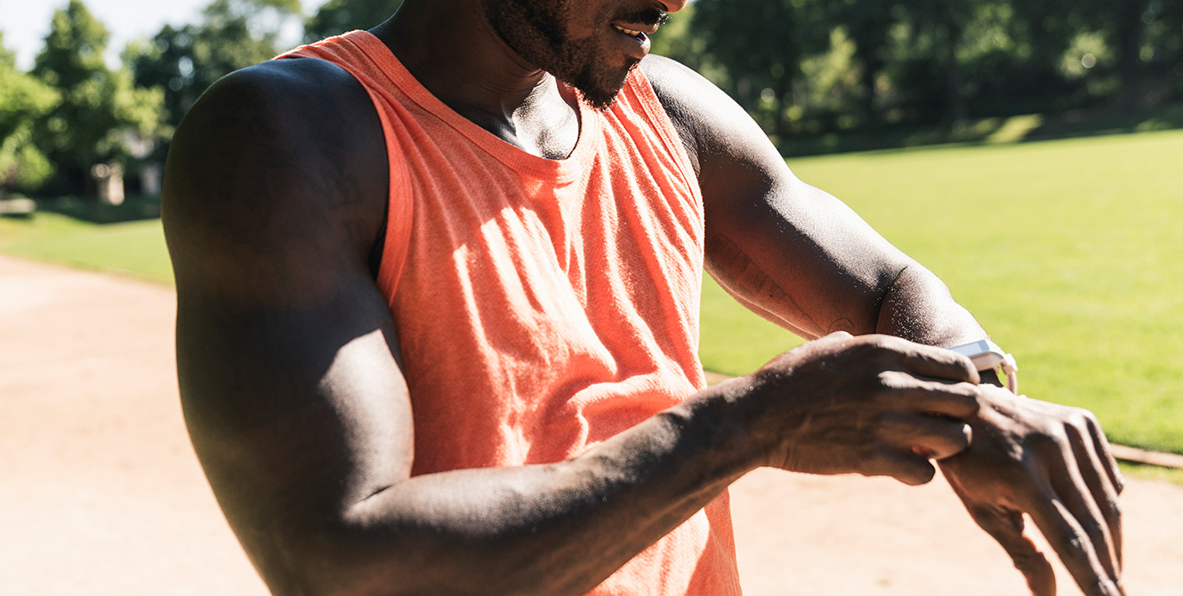 ncaa student athlete at liberty university training and checking smart watch